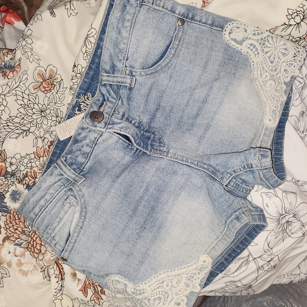 Justice Light Wash faded denim shorts with white lacing on bottoms